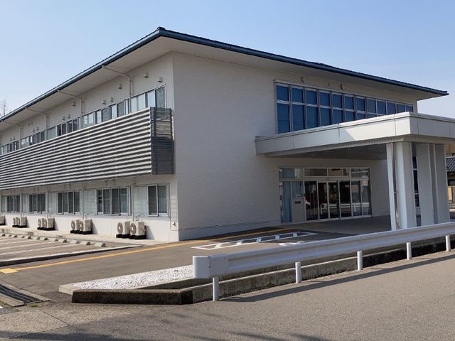 明るい建物のエントランス 外観 ゆったりとした入り口は明るく、訪れる方々を温かく迎え入れてくれます。自然光が射し込む空間で、皆様のお越しをお待ちしております。