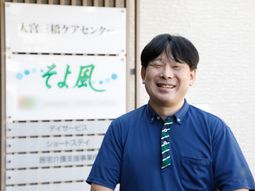 笑顔のスタッフと案内板