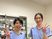 笑顔のスタッフ2人と調剤棚  