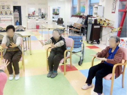 椅子に座る利用者とスタッフ