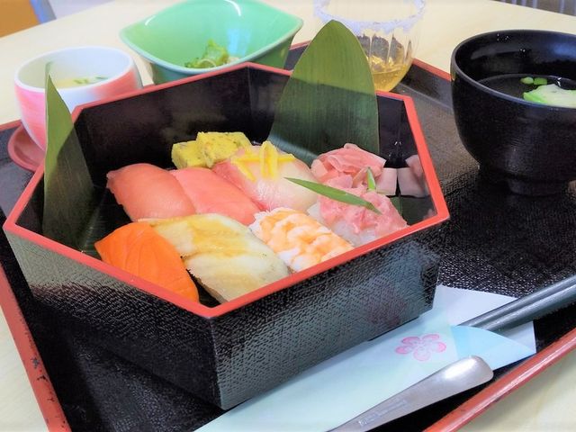 色とりどりの食事トレー 食堂 新鮮な寿司が並ぶ彩り豊かなメニューで、食事の時間がさらに楽しみになる空間です。