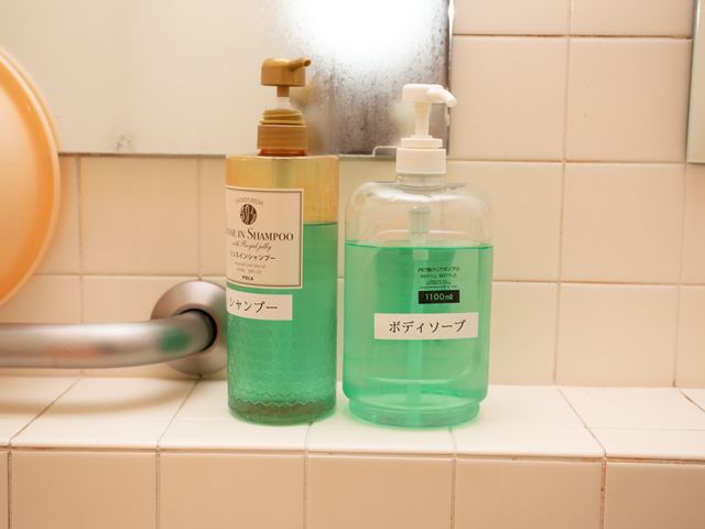 洗面台のシャンプーとボディソープ 備品 手すり付きの洗面台には、使いやすいシャンプーとボディソープが整っています。毎日の清潔を大切にされる方にも安心の設備です。