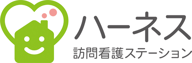 笑顔のロゴが特徴的な看板