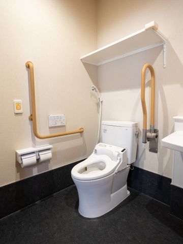 バリアフリー設計のトイレ トイレ 安全に配慮した手すり付きのトイレ環境。お客様のサポートに入る際も安心です。