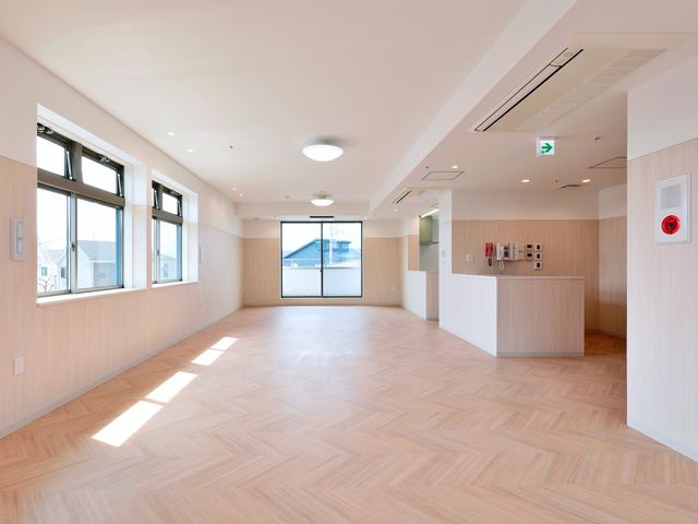 広々とした明るい居室 居室 床から天井まで続く窓から日差しが降り注ぐ、ゆったりとした居室です。開放的な空間で心地よい時間を過ごせます。