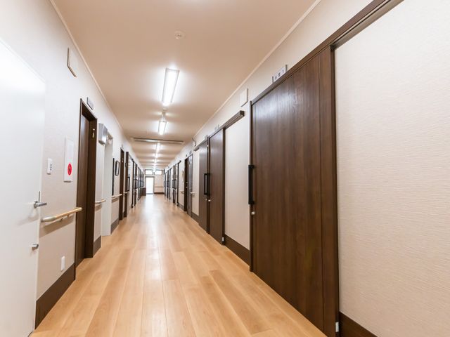 広々とした廊下 廊下 ゆったりとした造りの廊下が、快適な移動をお手伝いします。壁面の掲示が彩りを加え、活気ある空間を演出しています。