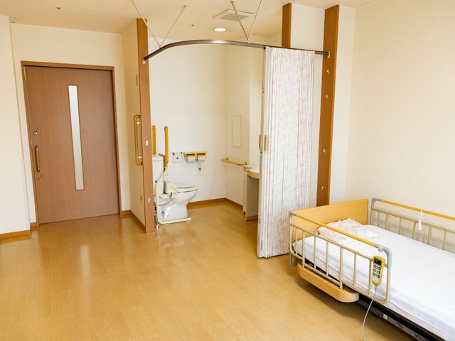 ゆとりのある居室 居室 広々とした空間にベッドとトイレが配置され、安らぎの個室空間を提供しています。プライバシーに配慮した設計で、快適な時間を過ごせることでしょう。
