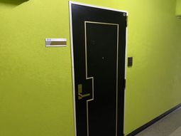 緑色の壁に面した居室の扉