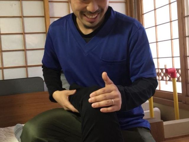 フレンドリーな介護士 居室 温かみのある和室で、介護士が笑顔で利用者のケアを行っています。リラックスできる和室です。