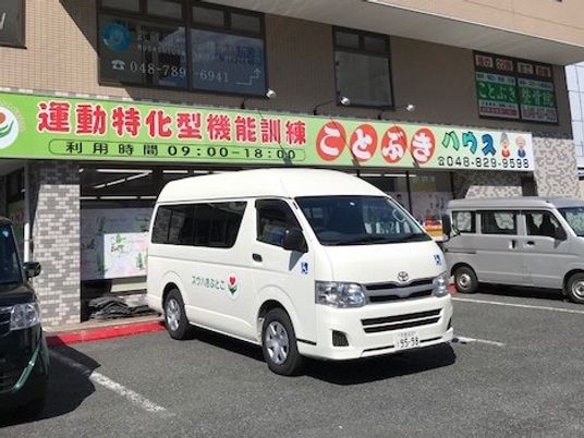 送迎車が停まる建物外観  