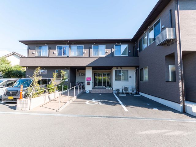 居心地よい施設の外観 外観 広々と開放的な敷地に建つ、落ち着いた色合いの建物です。バリアフリー設計の駐車スペースがあります。