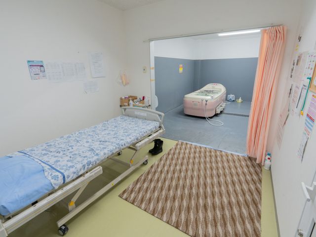 多目的室の様子 機械浴室 明るい多目的室は、介護ベッドと専用浴槽を備えています。快適に安心して利用できます。