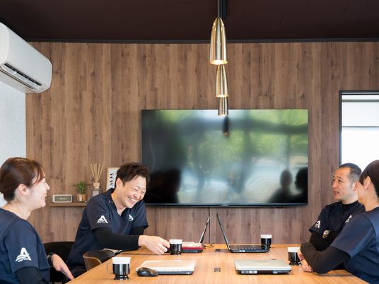 笑顔で話すスタッフの会議室  