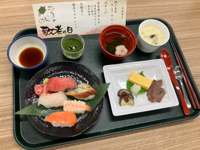 祝い膳の食事 料理   敬老の日を祝う華やかな膳です。握り寿司や煮物、茶碗蒸しが並び、季節感のある食事を楽しめます。