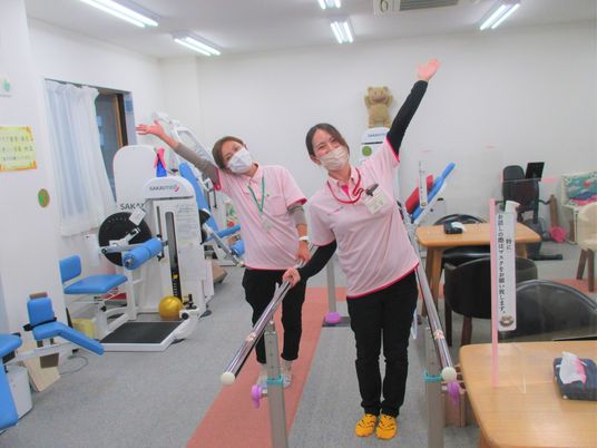 笑顔のスタッフと機器の部屋