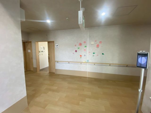 明るい廊下 廊下 木目調の床が広がり、壁には季節の飾りが施されています。人の通行がしやすく、快適な空間です。