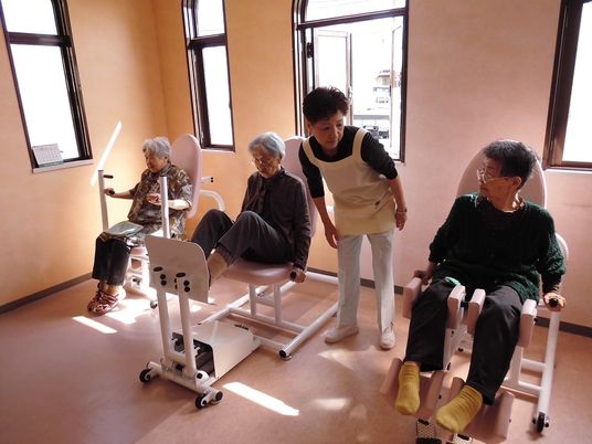 運動を行う高齢者とスタッフ