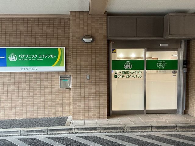 施設の外観 外観   落ち着いた色合いの外壁に、見学受付中の案内が掲示された出入口です。就業前の見学先として、施設の雰囲気を確認しやすいです。