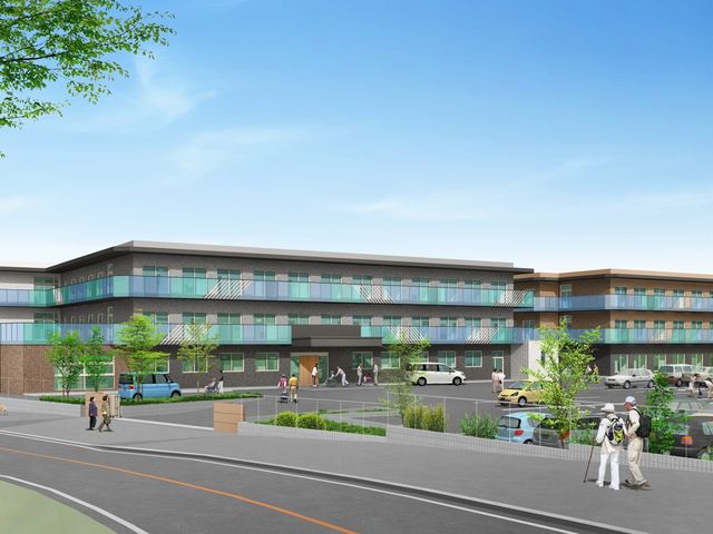 車が停まる建物外観 外観 広々とした駐車場と緑豊かな敷地が特徴の施設です。青空の下、多くの方が訪れる様子が伺えます。