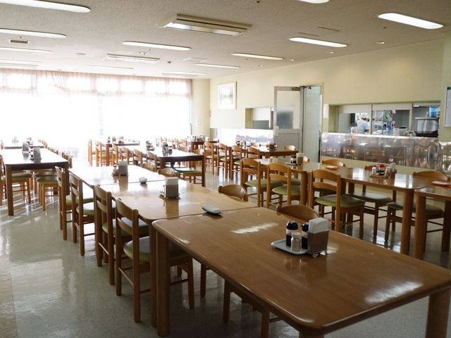 明るい広々とした食堂 食堂 ゆったりとした食事スペースが確保され、明るく開放的な雰囲気でお食事を楽しめます。キッチンで調理する様子も見え、安心感を与える設計です。
