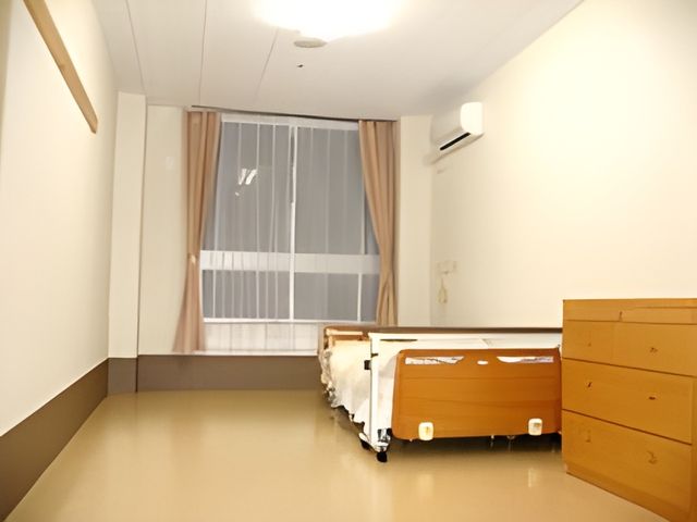 ベッドのある居室 居室 明るい日差しが差し込む広々とした空間で、快適に過ごせます。シンプルなインテリアが魅力です。