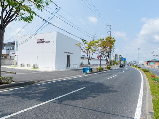 道路沿いの白い建物外観  