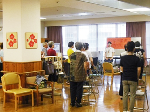 多目的室の風景 多目的室 自然光が差し込む明るい空間で、利用者が椅子に座って活動しています。快適な環境です。