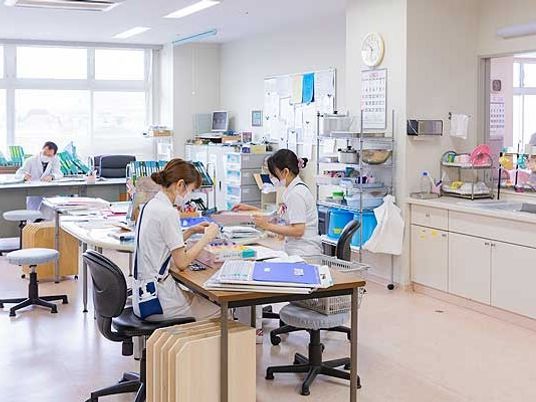 スタッフが作業する明るい部屋  