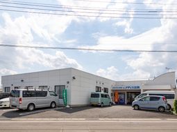白い建物と駐車場の外観