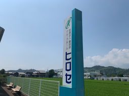 青空の看板と施設外観  