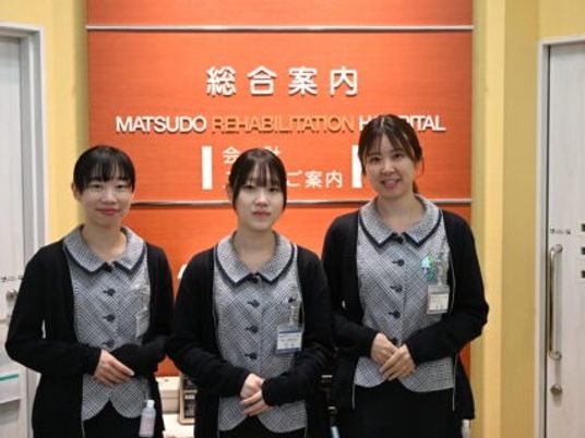 案内板前のスタッフ  