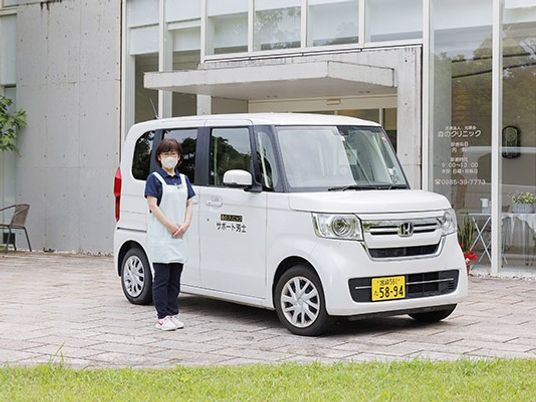 送迎車とスタッフの外観  