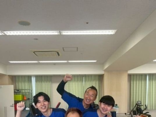 スタッフが並ぶ明るい室内  