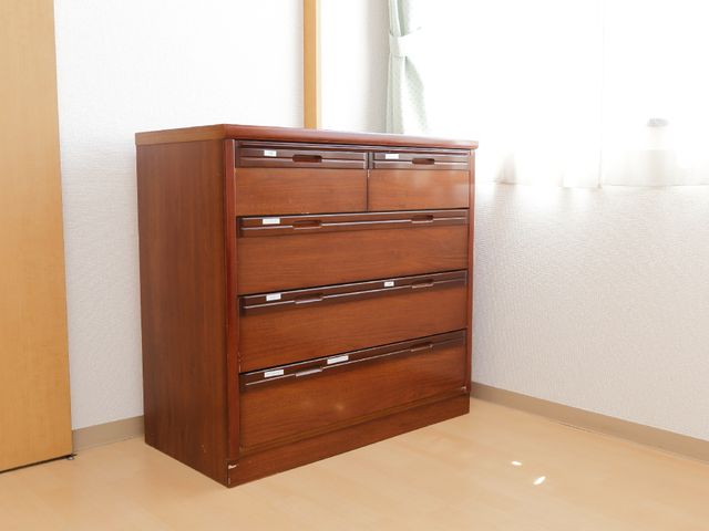 茶色のタンスが置かれた部屋 洋服ダンス。 広々とした室内には落ち着いた色調のタンスが配置され、居心地の良い空間を提供しています。