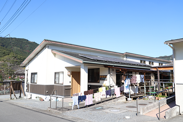 洗濯物が干された庭 外観 青空の下、洗濯物が風に揺れている場所です。働く人にとって、リラックスした環境が感じられます。