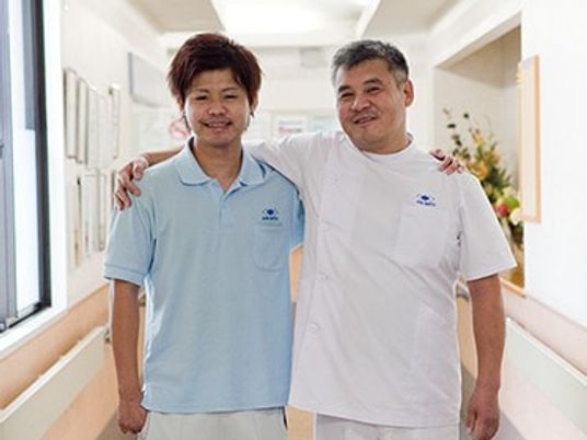 笑顔のスタッフ2人が並ぶ廊下  