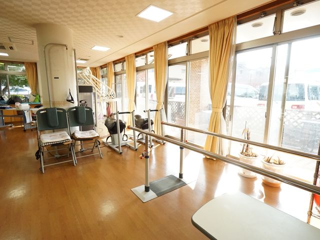 機能訓練用具と窓 共有スペース 天井からの自然光が降り注ぐ機能訓練室です。健康維持に役立つ訓練器具が整っており、明るく開放的な環境で働けます。