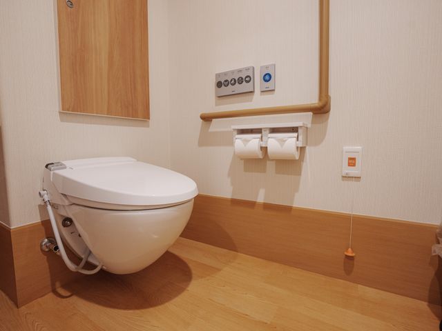 バリアフリーなトイレ空間 トイレ 安心して使える手すり付きのトイレです。清潔感ある壁紙と床材で居心地の良い環境が整っています。