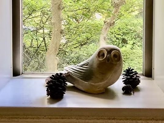 木彫りの置物がある窓辺  