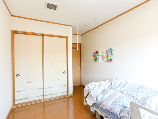 居室の明るい空間 居室 広々とした部屋には心地よい光が差し込み、壁には色鮮やかな装飾が施されています。