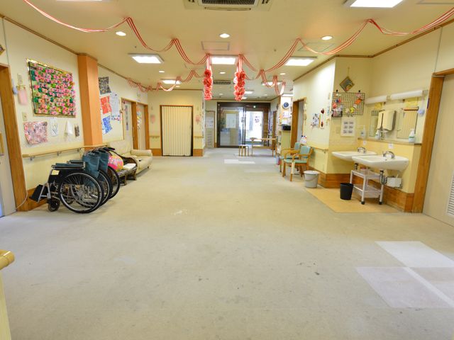 広々とした廊下の様子 ホールの飾り付け 広い廊下には、車椅子が並べられ、壁には利用者の作品が飾られています。お手洗いも設置され、清潔感のある職場環境をご体感いただけます。