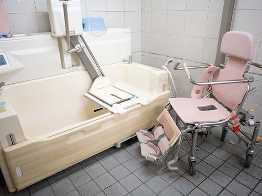 介護用浴槽と移乗椅子の浴室  