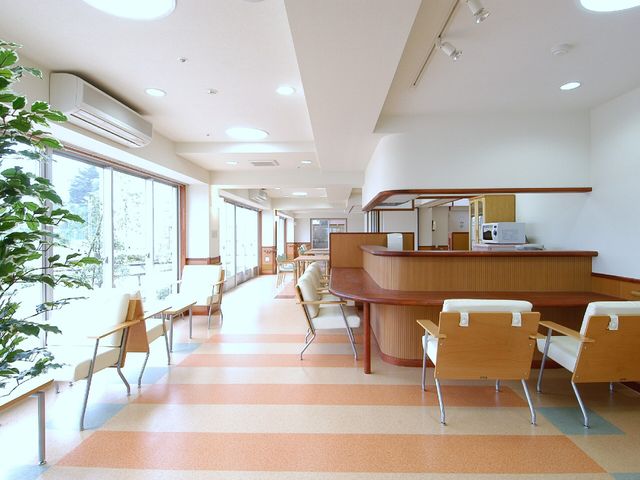 窓際に緑の植物あり廊下 カフェコーナー 自然光が差し込む清潔感のあふれる廊下です。訪れる方々の安らぎの空間となっています。