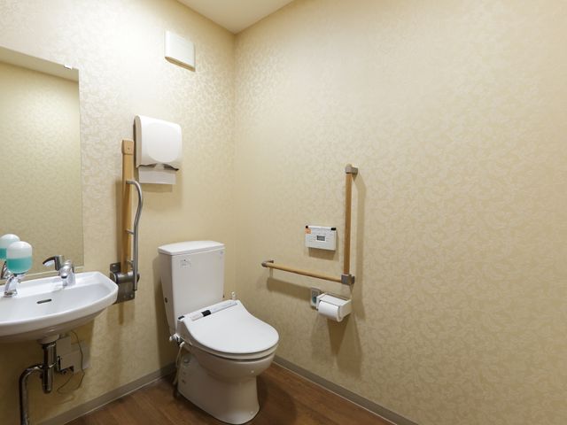 バリアフリーな洗面所 お手洗い 安心してご利用いただける手すり付きの清潔なトイレです。快適で安全な日々をサポートする設備を備えています。