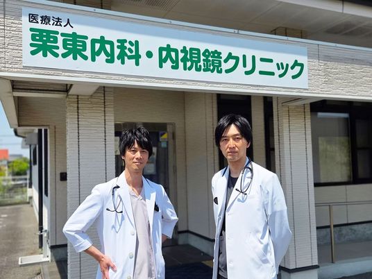 医師が並ぶクリニック前