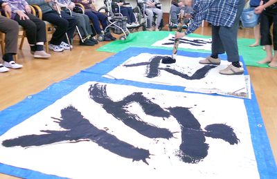 大きな書道用紙と人々の集まり