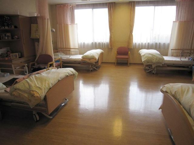 多床室の居室 居室   自然光が差し込む明るい居室です。ベッドが複数配置され、落ち着いて過ごせる空間になっています。