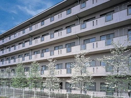 春の木々と建物の外観