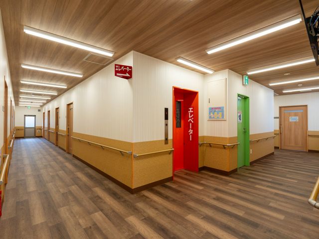 機能的な廊下 廊下 木目調の明るい廊下で、利用者のための安全な手すりが設置されています。スタッフにも優しい動線です。