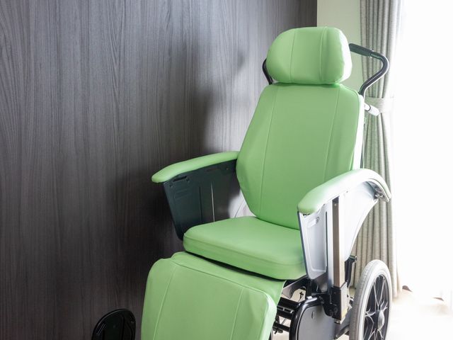 緑色の車椅子の部屋 居室 明るい居室には、快適さを追求した緑色の車椅子が設置されています。自然光が差し込み、リラックスできる空間です。